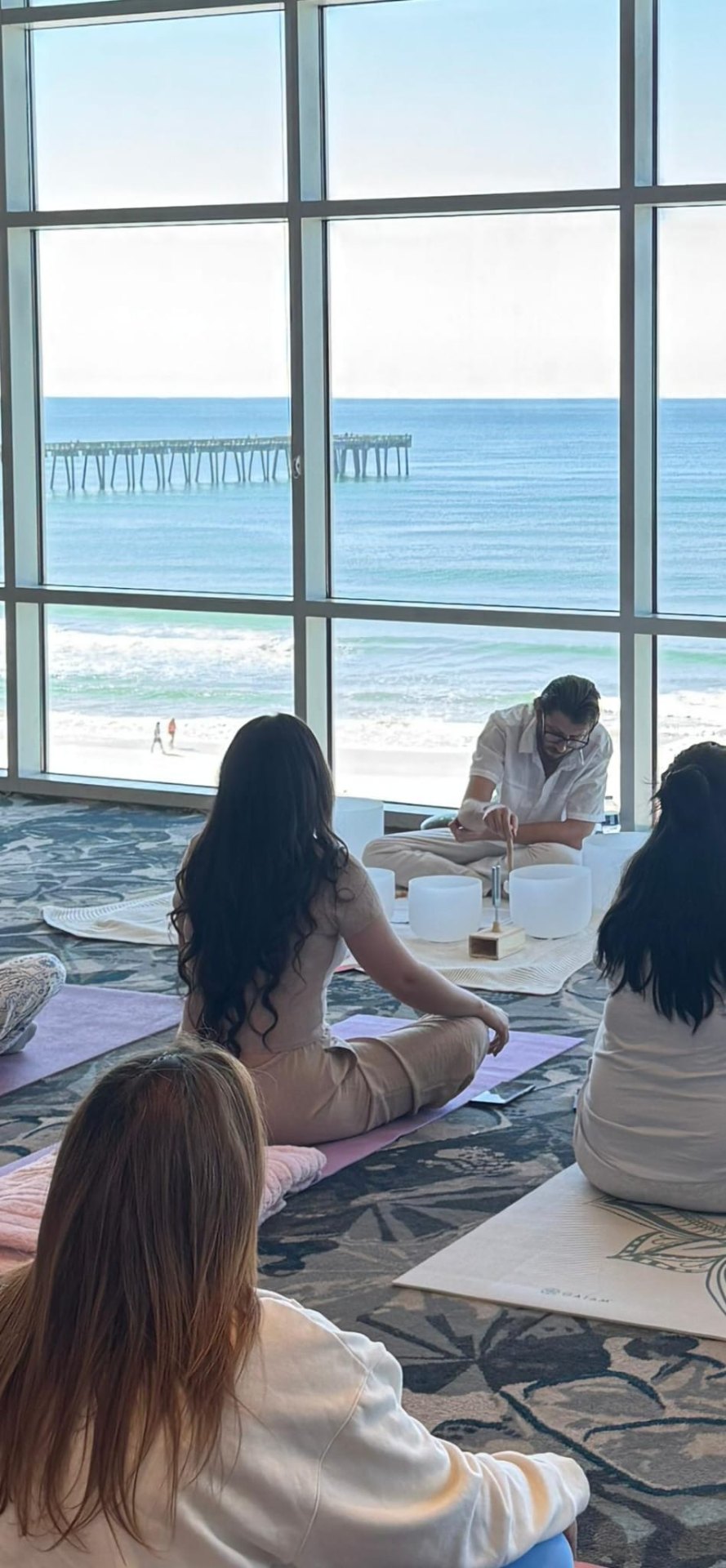 Keifer guiding a sound healing session by the Gulf