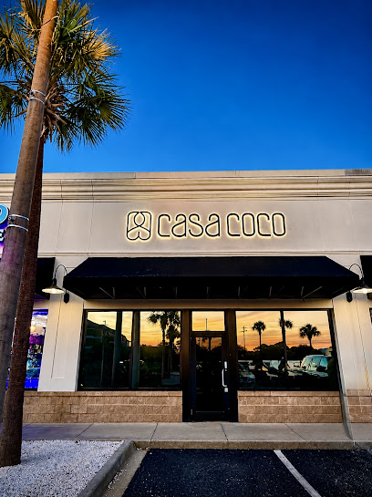 Casa Coco Nail Salon entrance at dusk